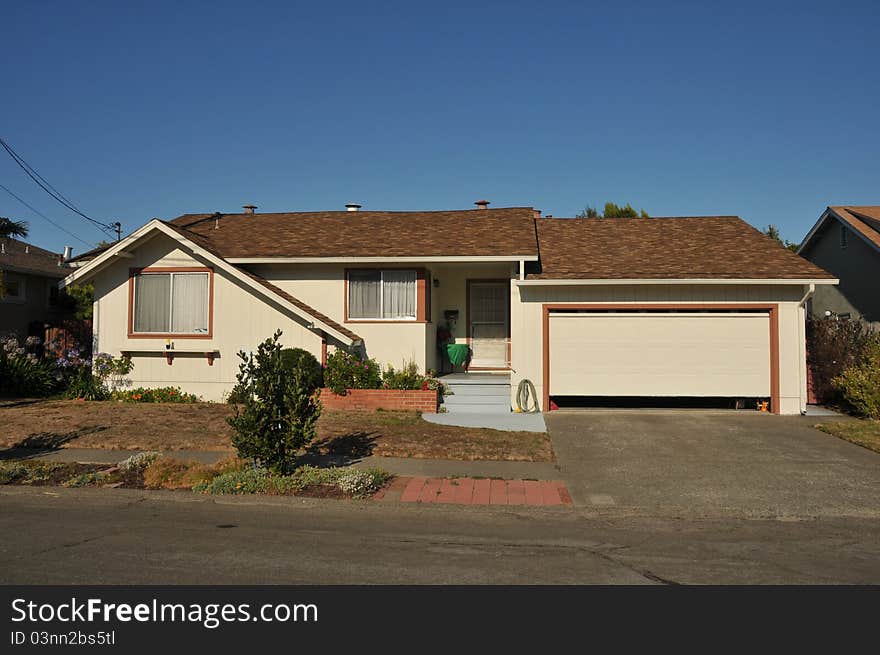 Single family house with one story and a short driveway. Single family house with one story and a short driveway