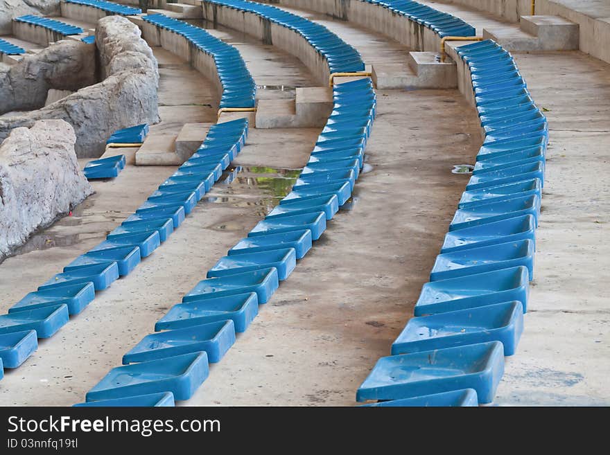 Old plastic blue seats on stadium