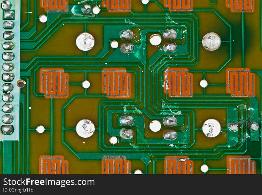 The modern printed-circuit board with electronic components macro background. The modern printed-circuit board with electronic components macro background