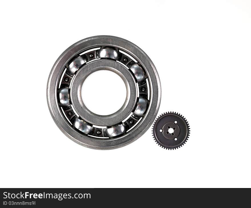 A bearing and gear cog isolated against a white background. A bearing and gear cog isolated against a white background