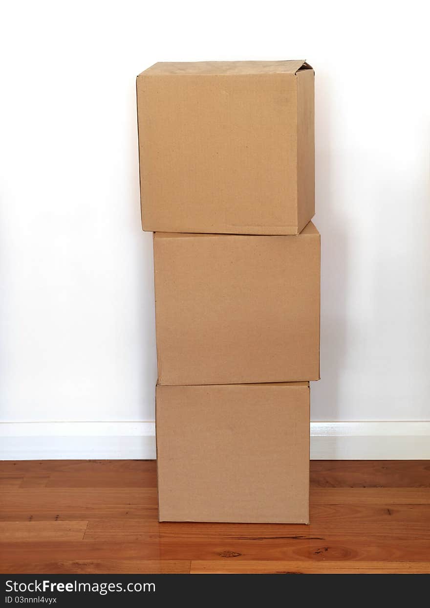 Cardboard boxes on a wooden floor. Cardboard boxes on a wooden floor