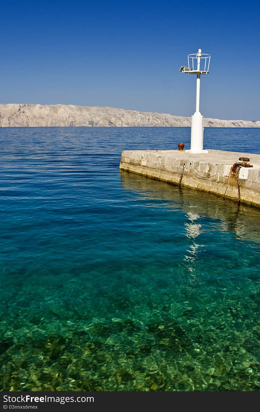 Beautiful emerald waters and coast with the pier and lighthouse. Beautiful emerald waters and coast with the pier and lighthouse