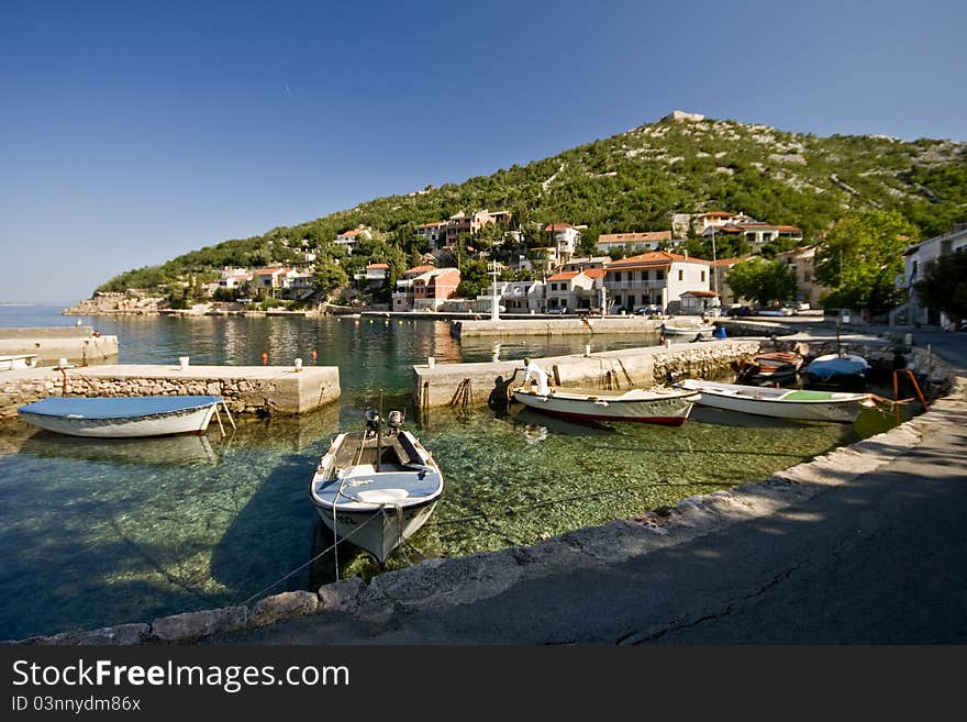 Small green water port and the fishing boats. Small green water port and the fishing boats