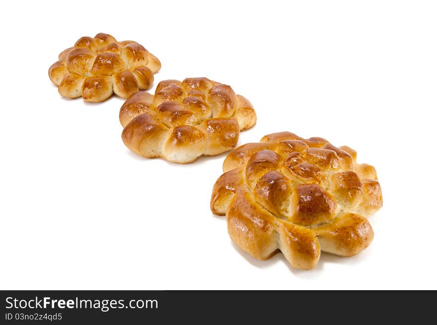 Three delightful baked rolls on a white background. Three delightful baked rolls on a white background