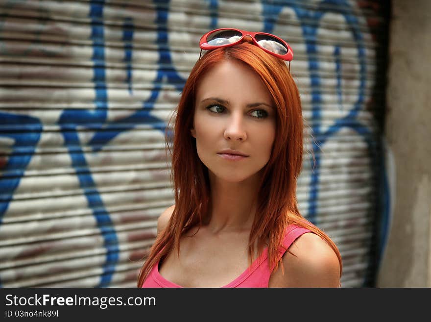 Beautiful young girl in front of a graffiti wall. Beautiful young girl in front of a graffiti wall