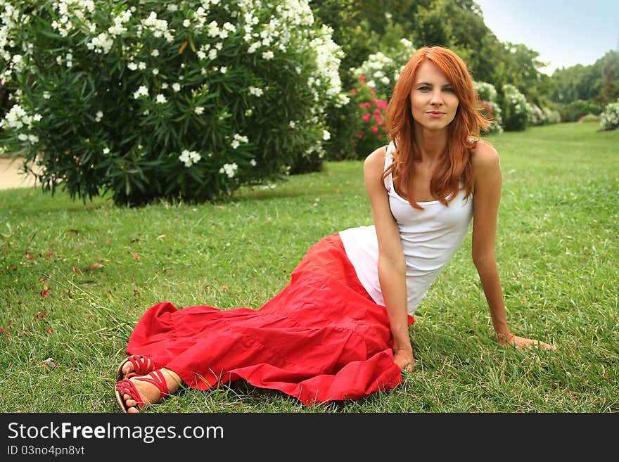 Beautiful young woman relaxing in park. Beautiful young woman relaxing in park