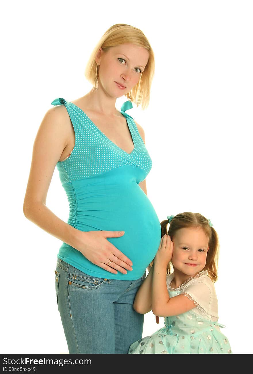 Cute girl embracing her pregnant mother