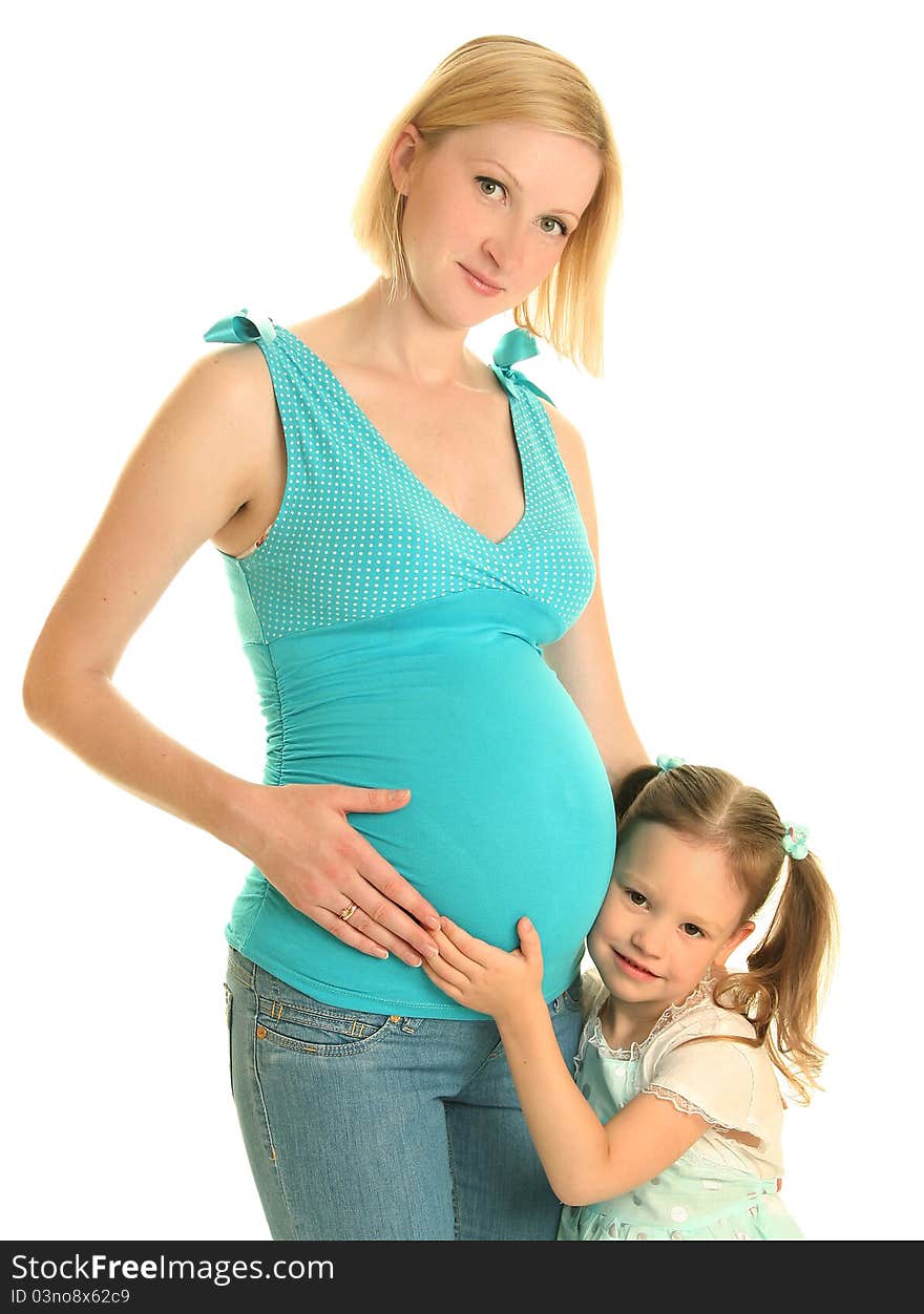 Cute girl embracing her pregnant mother