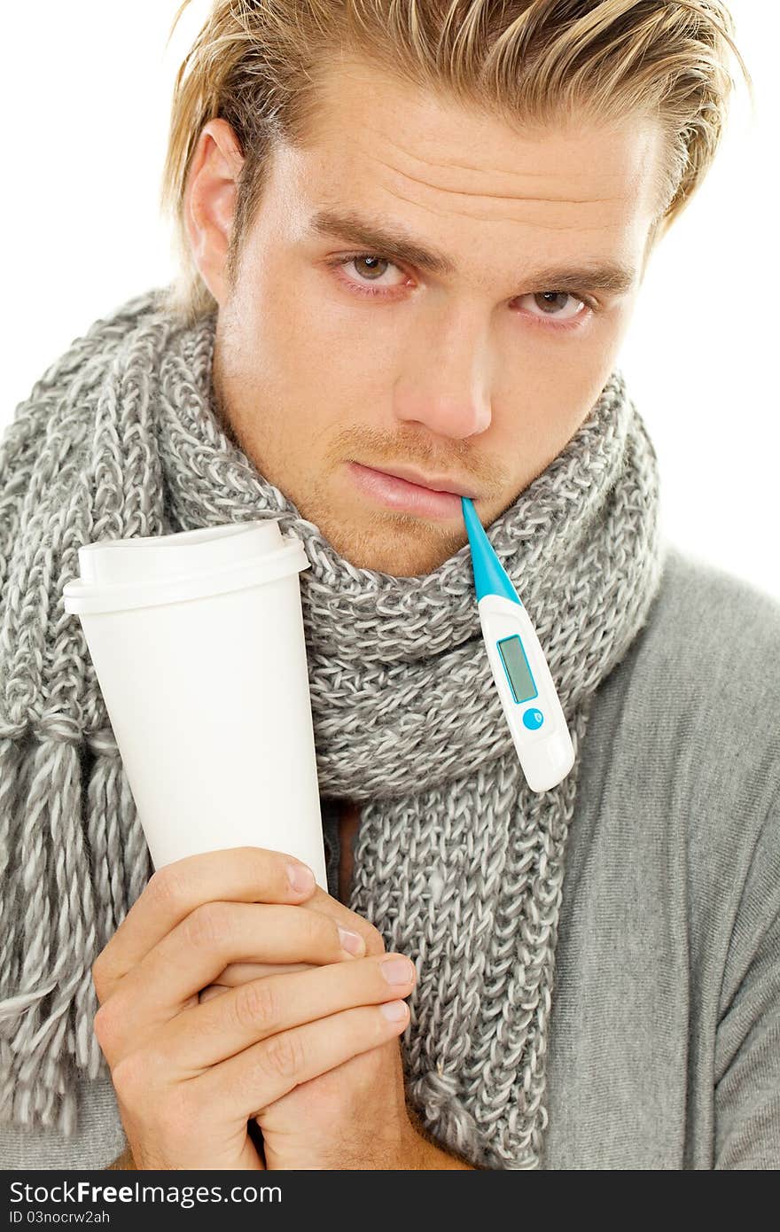 Blond man holding thermometer and cup. Blond man holding thermometer and cup