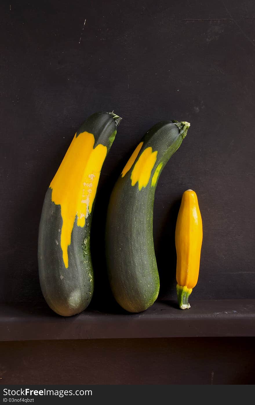 Three aubergine on black background