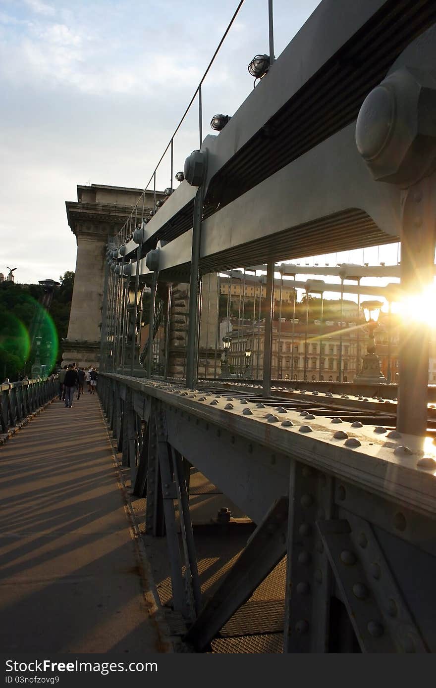 The Chain Bridge is a suspension bridge that spans the River Danube between Buda and Pest, the west and east side of Budapest, the capital of Hungary. The Chain Bridge is a suspension bridge that spans the River Danube between Buda and Pest, the west and east side of Budapest, the capital of Hungary