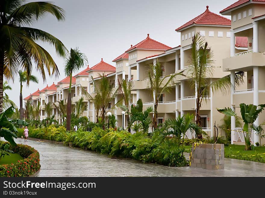 Street in a Dominican republic hotel with beige houses in summer