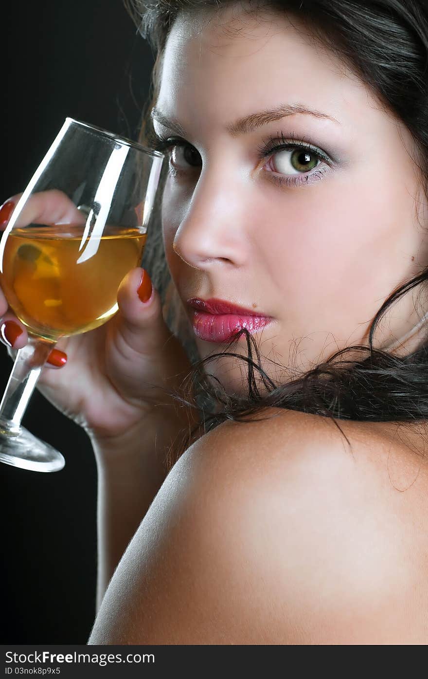 Beautiful girl with wine glass on black background