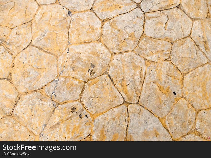 Beige background of stone texture wall in daylight