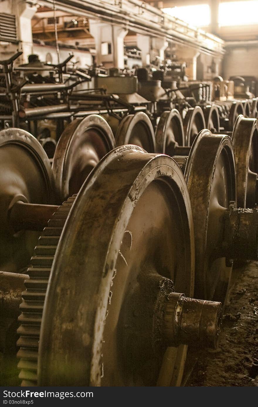 An old industrial wearhouse inside the train depot. The storage room for used,old or spare wheels. Also the mechanical service operations took place in the back. An old industrial wearhouse inside the train depot. The storage room for used,old or spare wheels. Also the mechanical service operations took place in the back.