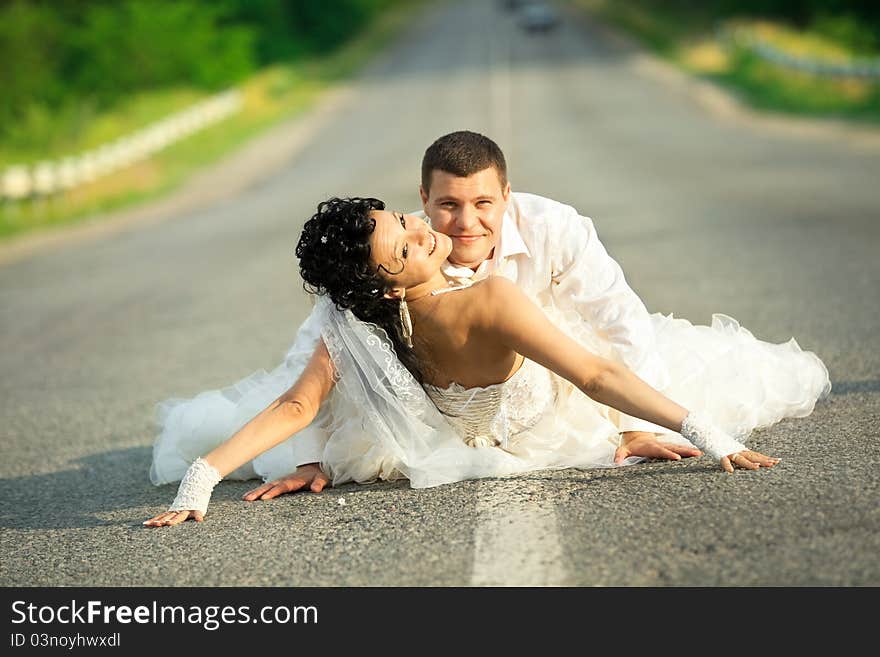 passion between bride and groom on countryside road