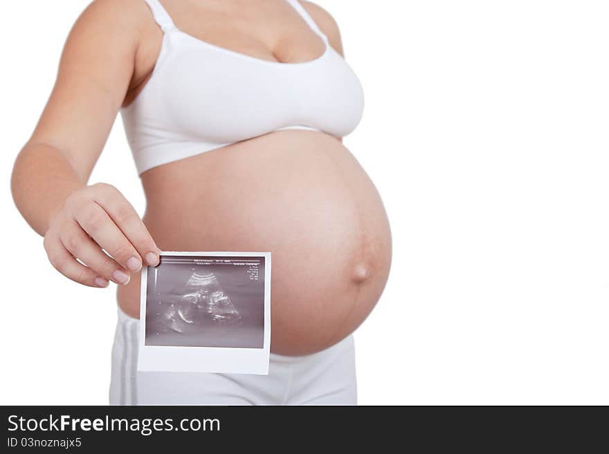 Pregnant woman hold in hand ultrasound investigation picture on a belly