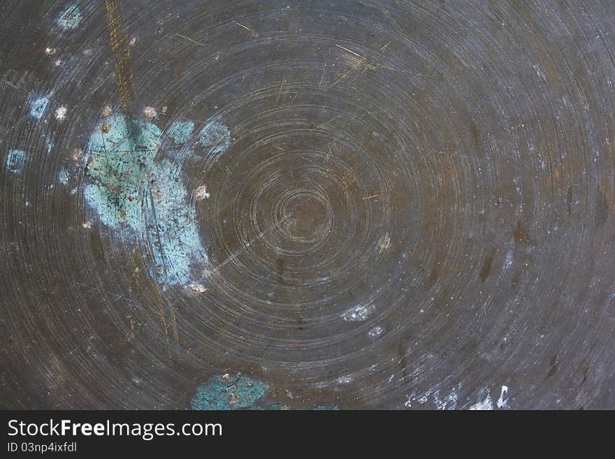 Grunge metal background with scratches in the form of a spiral