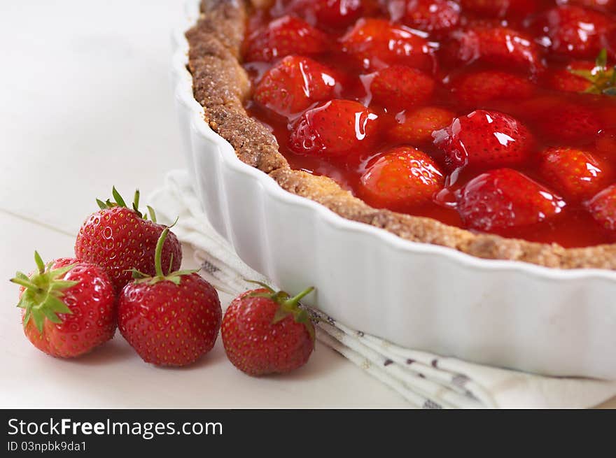 Sweet strawberry pie on a white table. Sweet strawberry pie on a white table