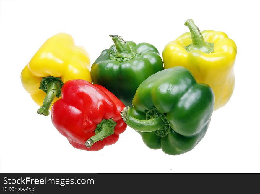 Three colors of sweet peppers on white.