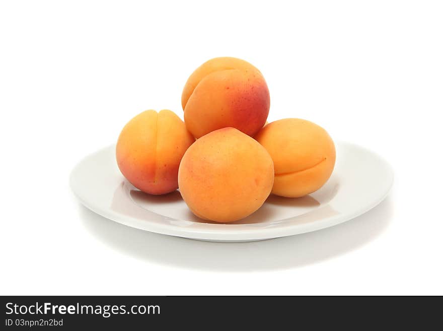 Ripe apricots on white plate. Ripe apricots on white plate