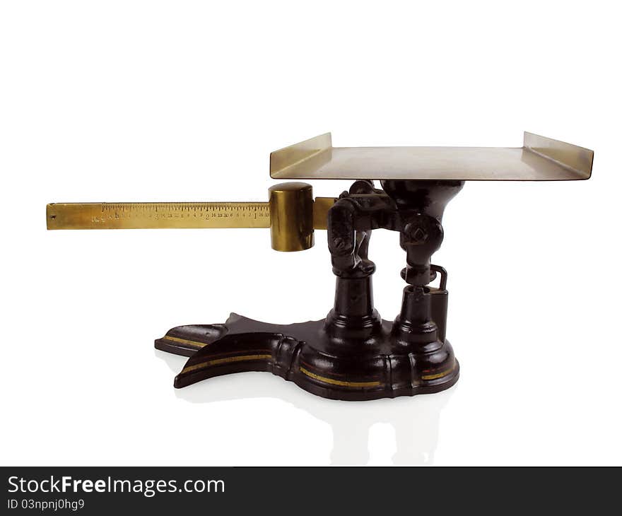 Antique balance or scale in brass on a white background. Antique balance or scale in brass on a white background