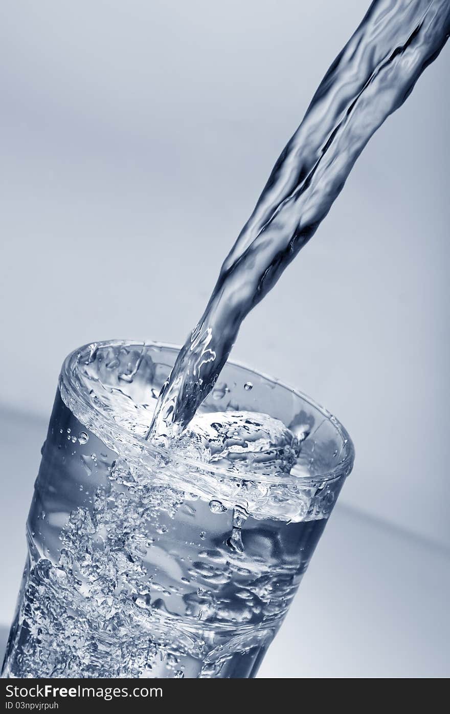 Fresh water pouring into a  glass