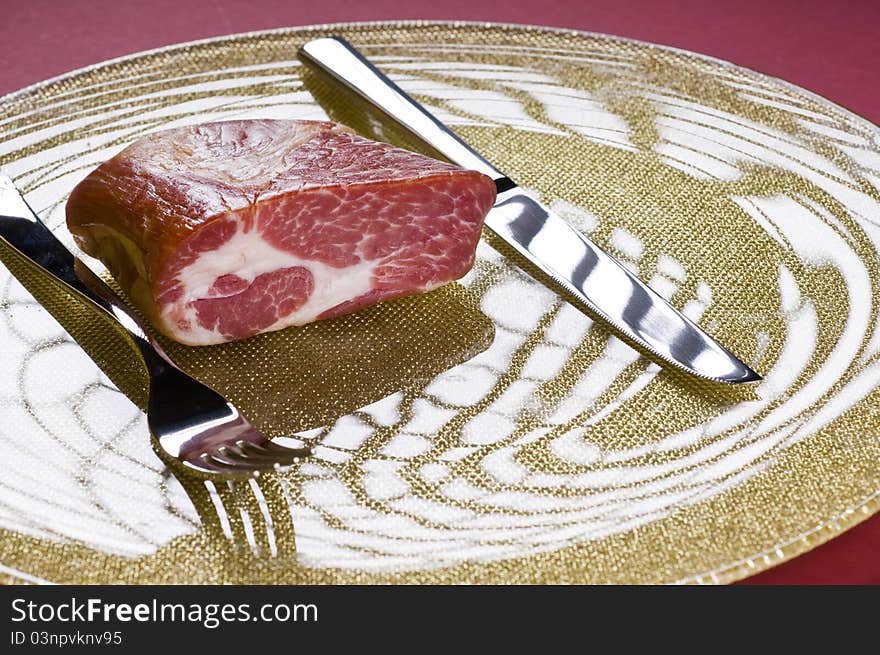 Raw meat on a plate over color background