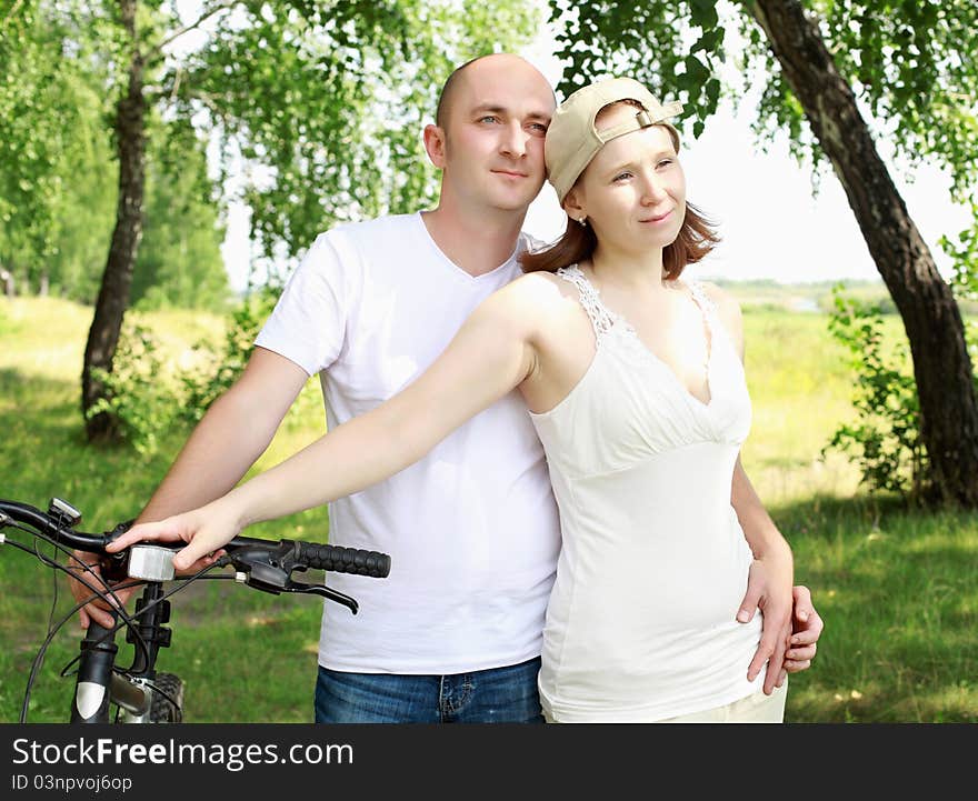 Young couple on the bikes in the summer park. Young couple on the bikes in the summer park