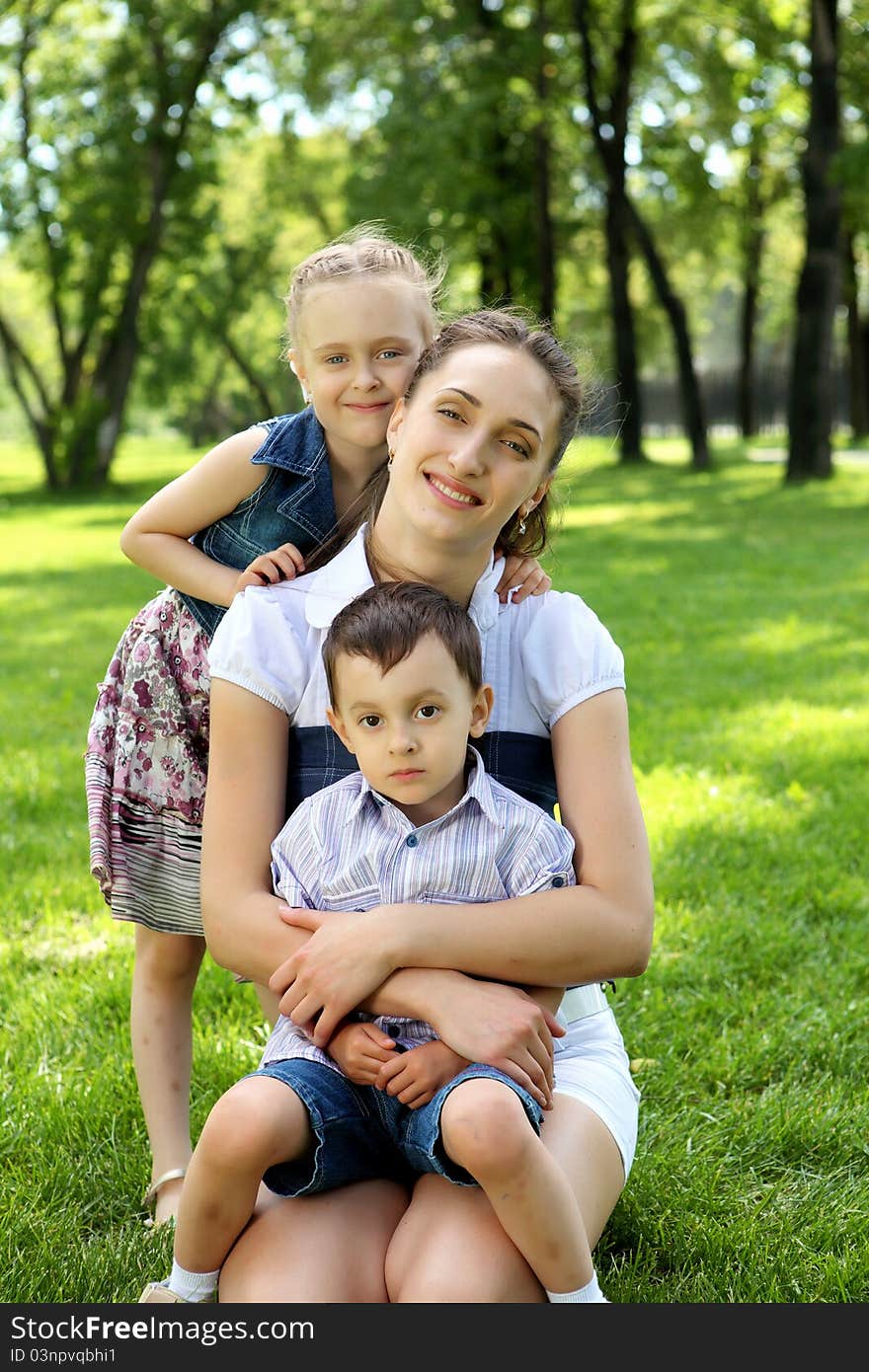 Mother with dausghter and son together in the park