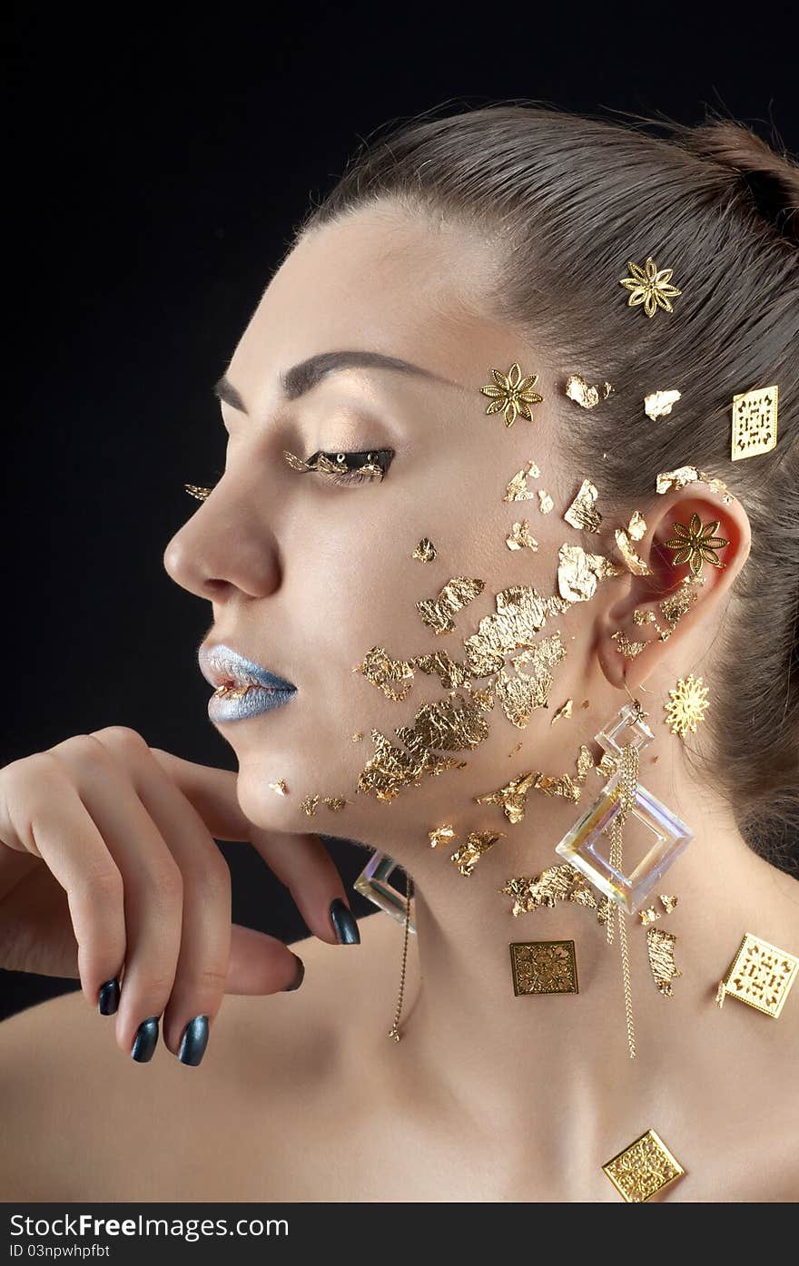 Close-up portrait of beautiful brunette with golden glamor make-up