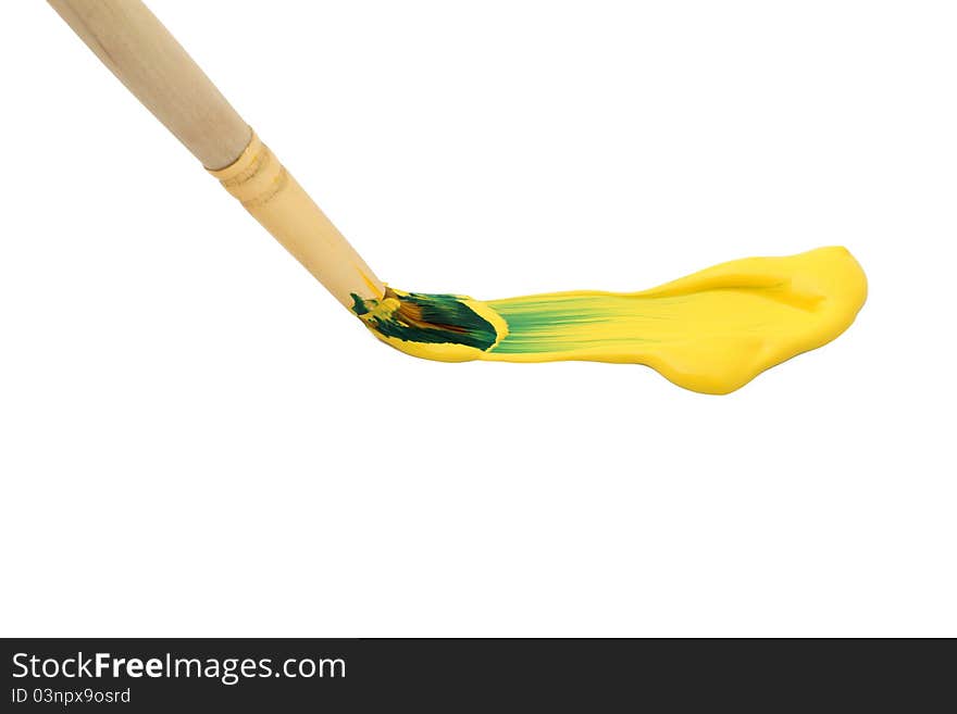 Paintbrush with yellow paint isolated on white background