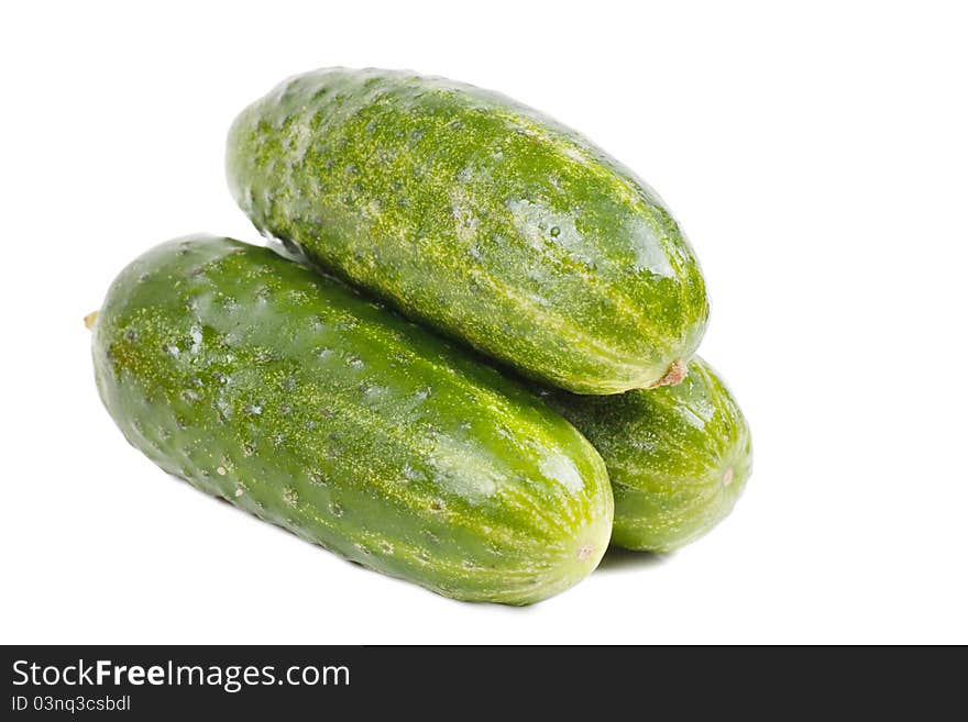 Three fresh green cucumbers over white background. Three fresh green cucumbers over white background