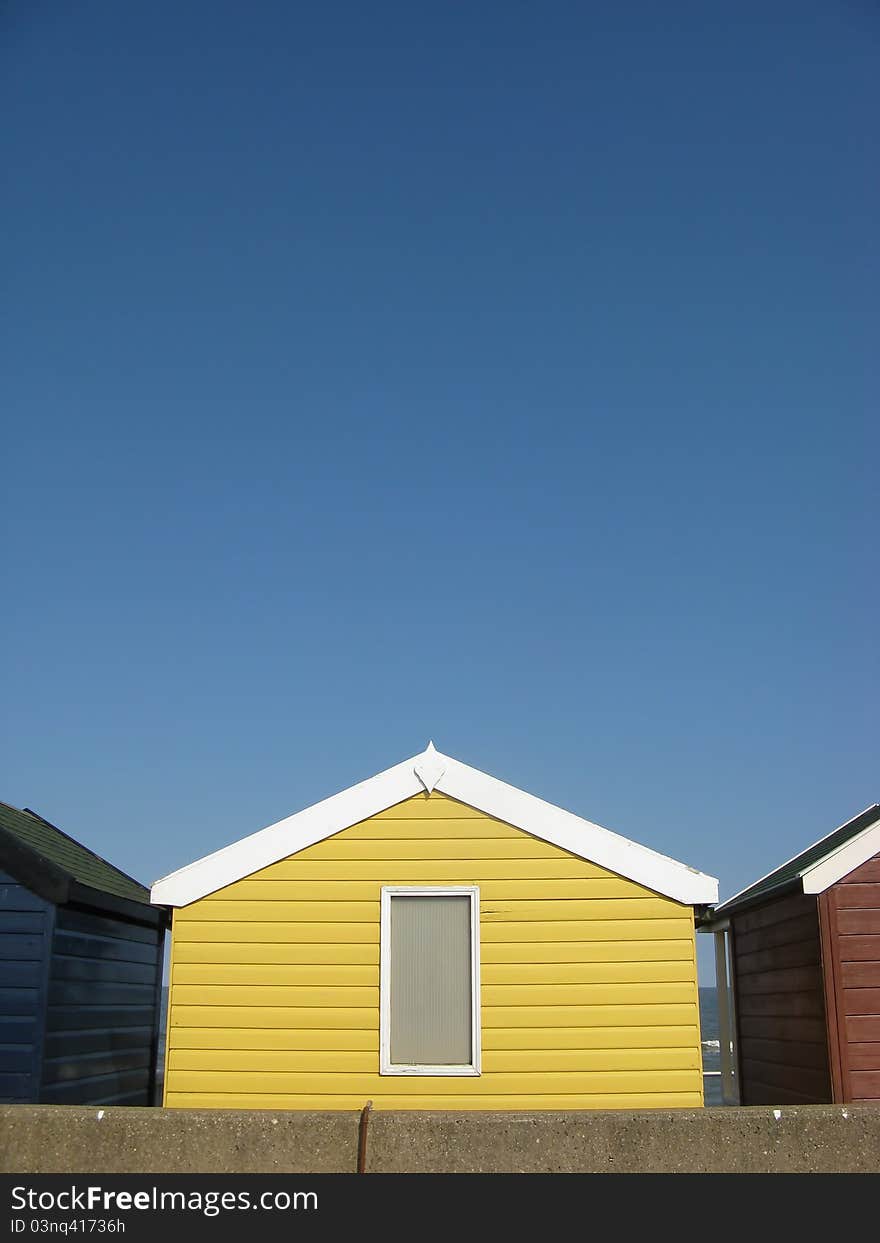 Bright Yellow Beach Hut On An English Beach