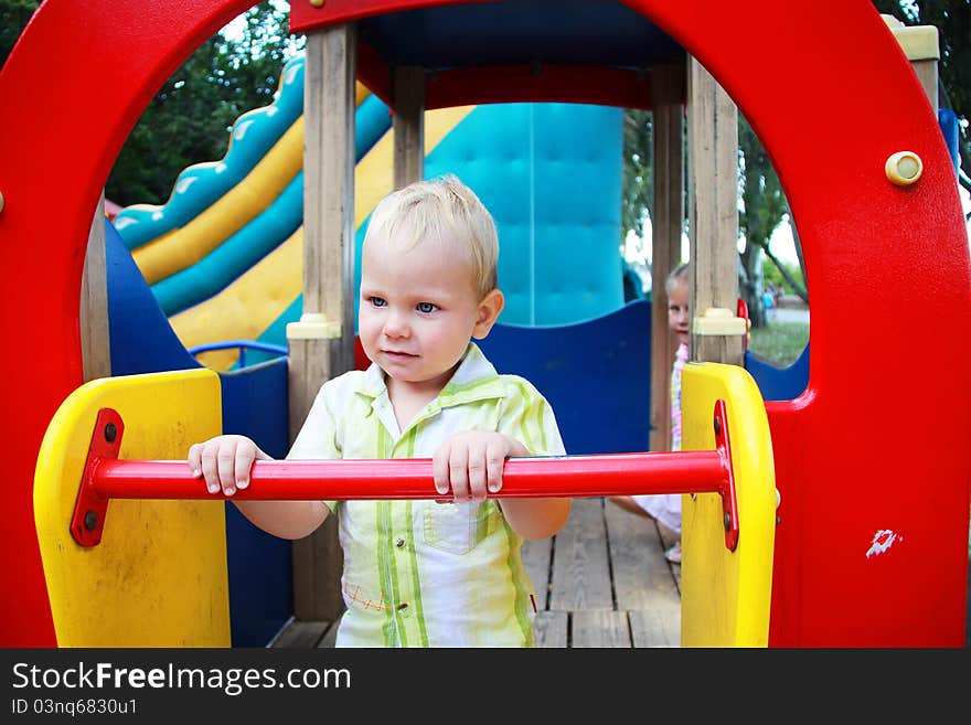 The kid in the playground. Summer.