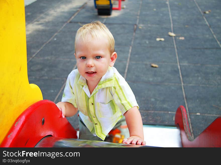 The kid in the playground. Summer.