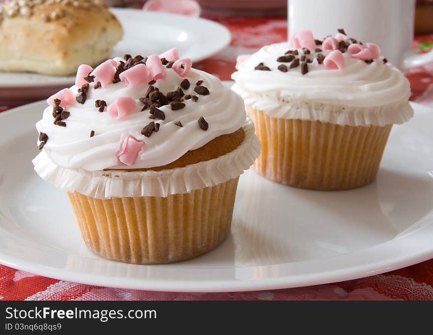 Delicious cupcakes on a plate on a table ready to be eaten.