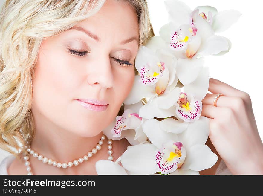 Close-up portrait of beautiful young blonde woman with  flowers  of orchid on isolated white background. Close-up portrait of beautiful young blonde woman with  flowers  of orchid on isolated white background