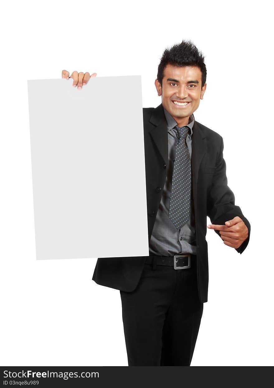 Businessman holding a blank sign, one finger pointing to the sign