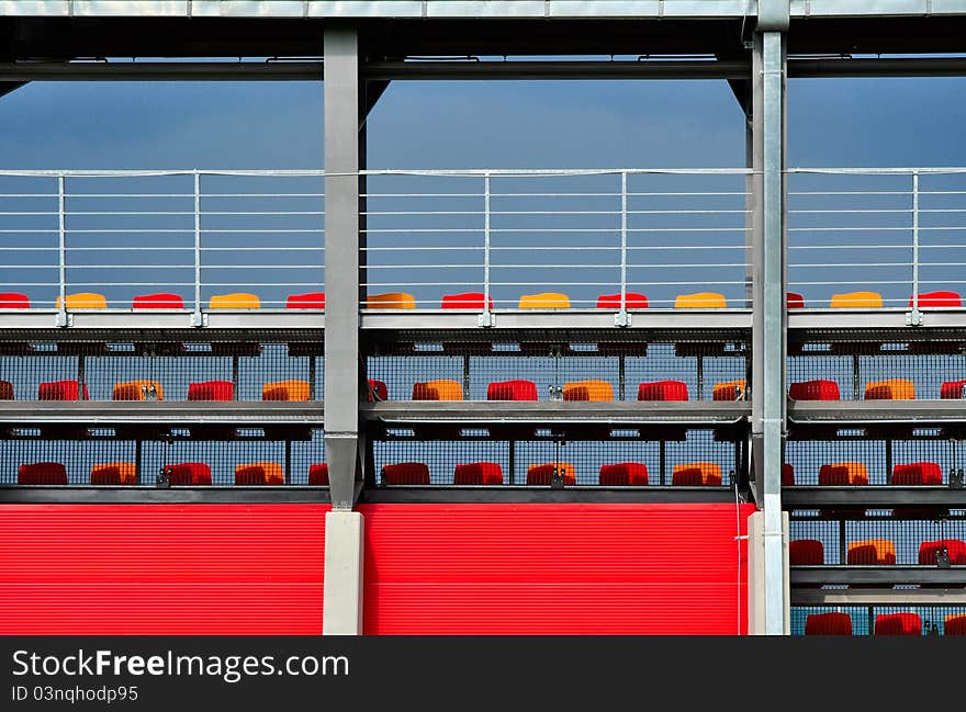 Sport stadium or tribune architecture with colorful empty seats, abstract background. Sport stadium or tribune architecture with colorful empty seats, abstract background.