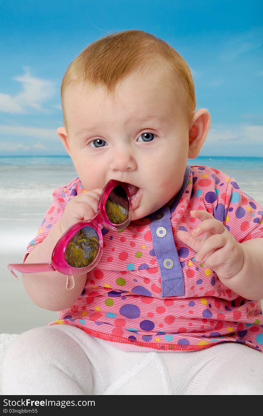 Sweet baby on vacation on beach with the sea in the background. Sweet baby on vacation on beach with the sea in the background.