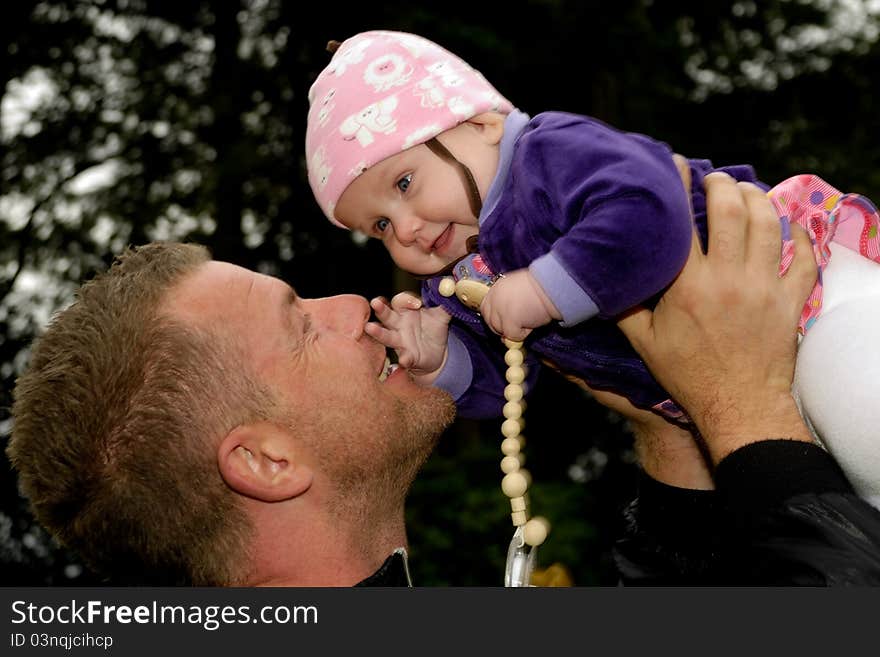 Happy father is lifting up his smiling baby. Happy father is lifting up his smiling baby