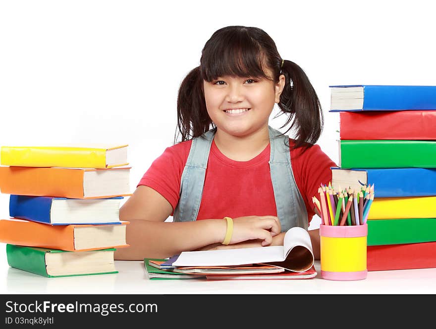 Image of schoolgirl smiling with the heap of books against white background. Image of schoolgirl smiling with the heap of books against white background