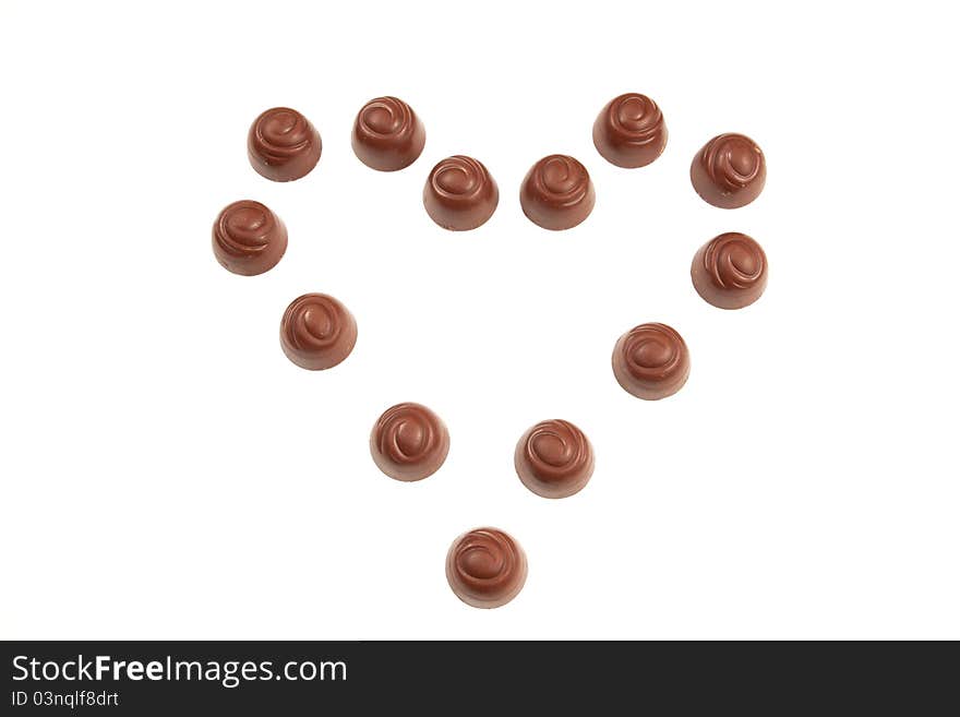 Selection of fine pralines of chocolate, placed in the shape of a heart. Selection of fine pralines of chocolate, placed in the shape of a heart