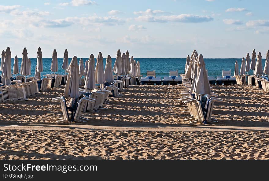 View of the beach with loungers and umbrellas. View of the beach with loungers and umbrellas.