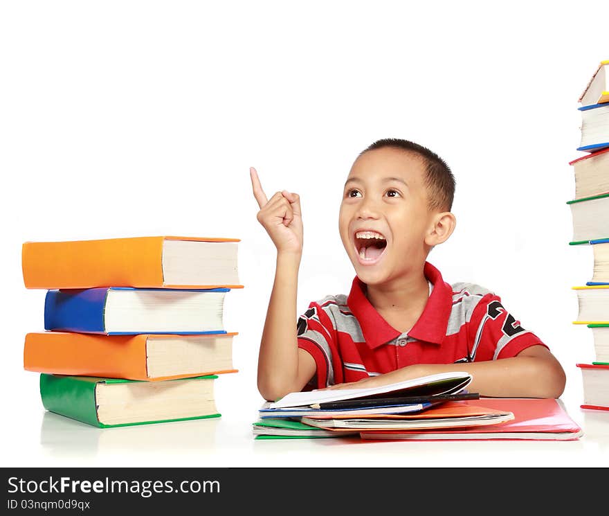 Portrait of happy joyful little boy pointing into copy space against on white background