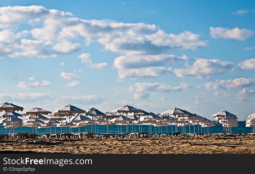 View of the beach with loungers and umbrellas. View of the beach with loungers and umbrellas.