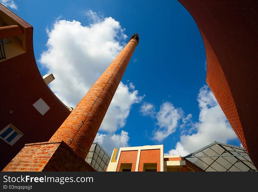 Modern Building with appartments and old chimney with nest. Modern Building with appartments and old chimney with nest