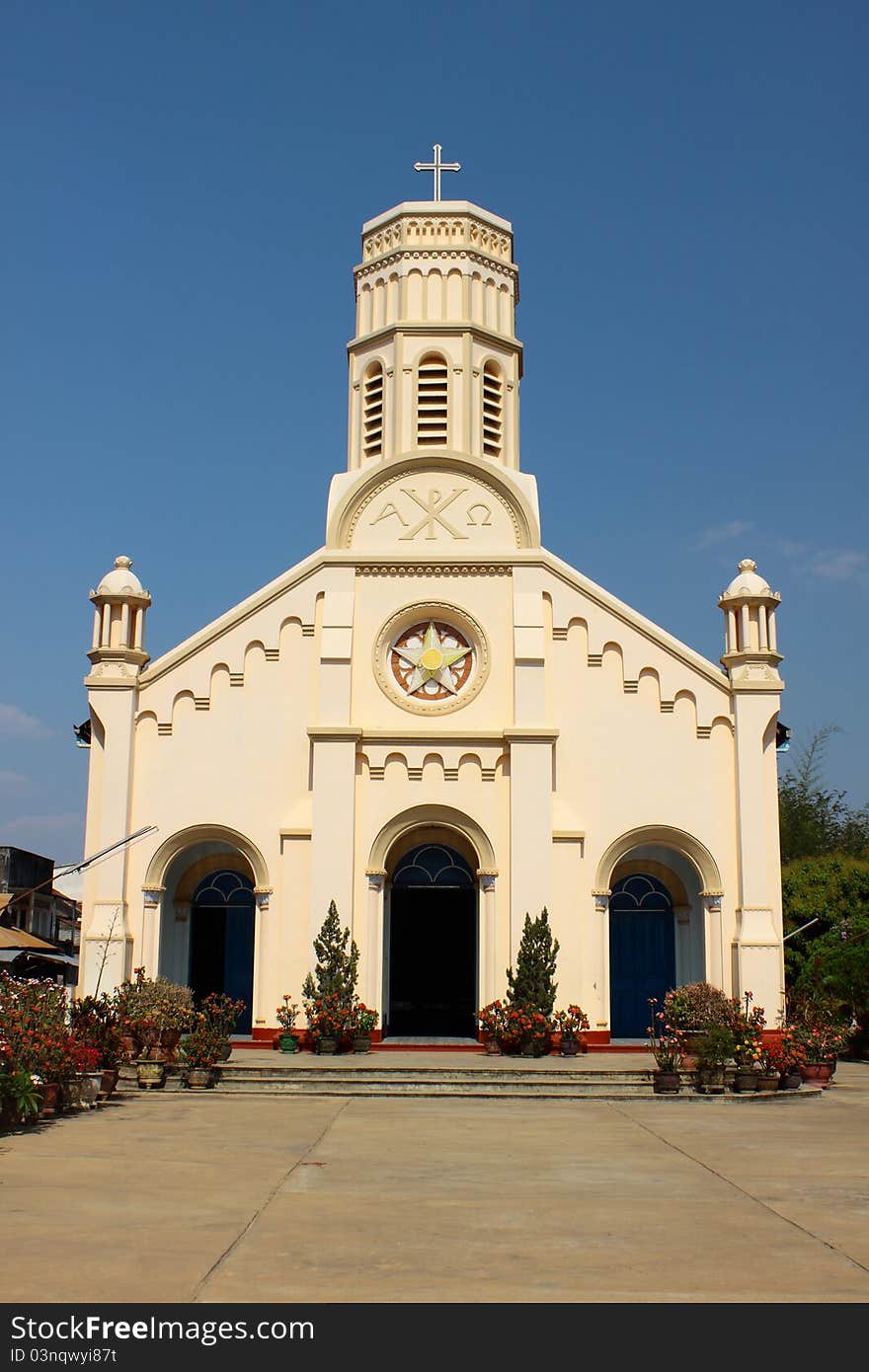 Pastel Yellow Church Against Blue Sky In Lao PDR.