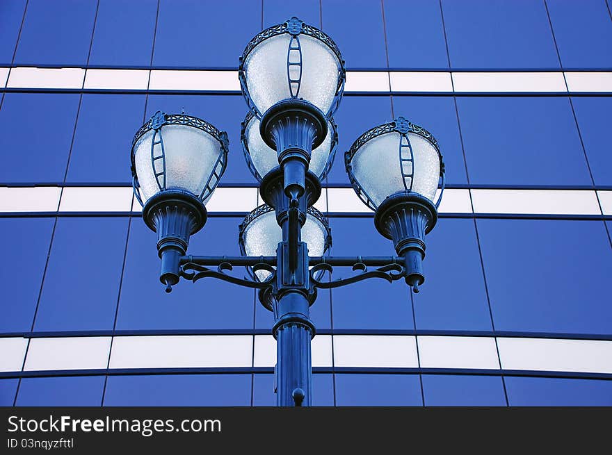 Ornate street lights with blue windows in background